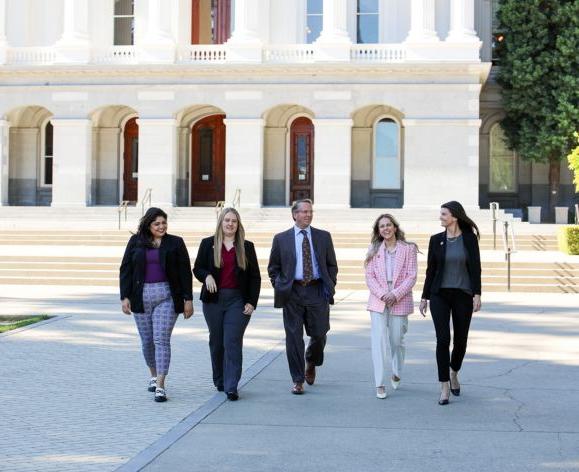 students and professor walking in front of the Capitol